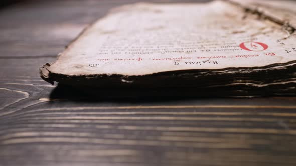 Slider Shot Over Pages with Candle Wax Stains of Old Antique Religious Book