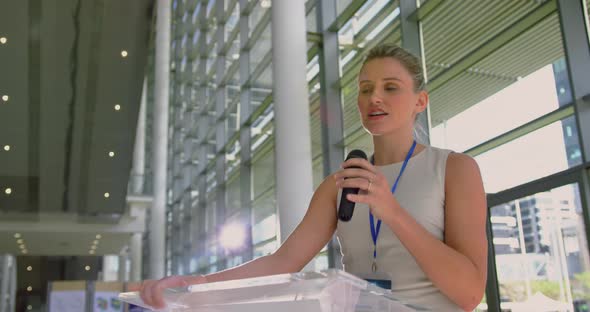 female speaker speaks in a business seminar at modern office 4k