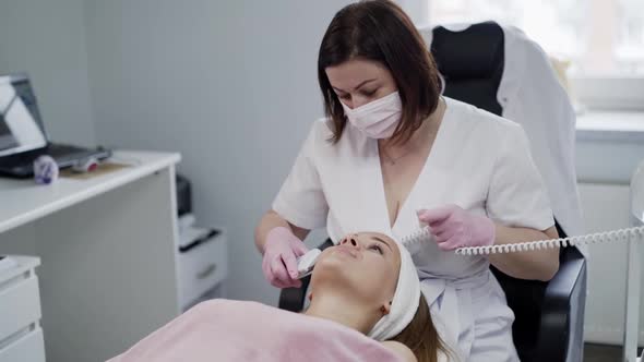 Cosmetological Ultrasonic Facial Cleansing for a Young Woman in Beauty Clinic