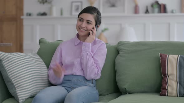 Indian Woman Talking on Phone on Sofa