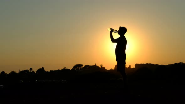 Silhouette Young Drinking Water