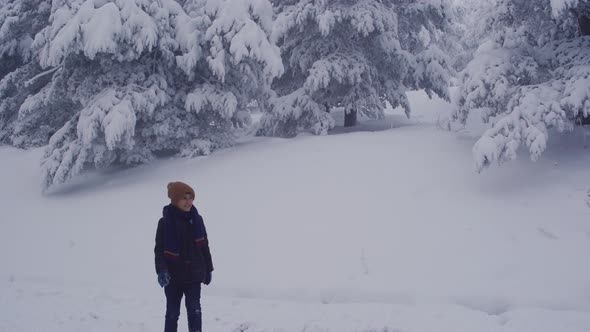 Boy walking in snow.