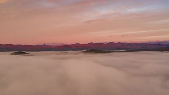 Timelapse of the sunrise on the White Mountains over the clouds AERIAL STATIONARY