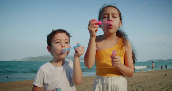 Happy Children Playing with Soap Bubbles