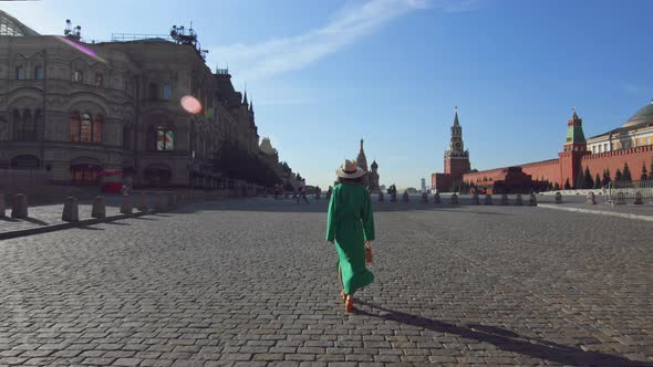 Attractive girl walking on Red Square in summer