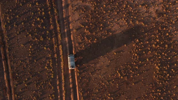 Aerial View Off Road 4X4 Car Driving Along Dirt Road Among the Desert