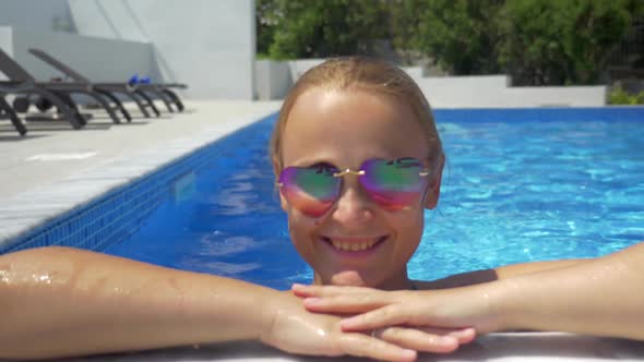 Woman in Sunglasses Enjoying Sunny Day in the Pool