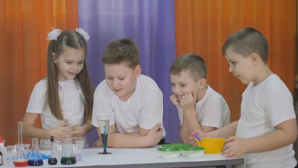 Chemical Experiments for Children. Fun Experiments for Children. Woman Adds Pills To a Clear Glass