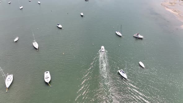 An aerial view of the Northport Marina on Long island, NY with several anchored boats on a sunny day