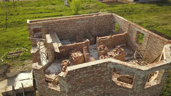 Aerial view of unfinished house interior walls under construction at building site.