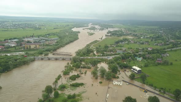 Aerial View of the Overflowing River. Flooded Buildings and Roads. Extremely High Water Level in the