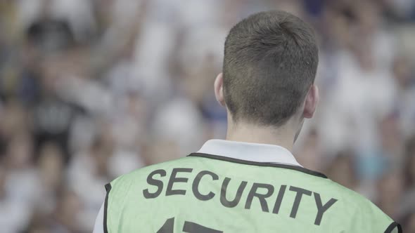 Male Security Guard in a Stadium During a Football Soccer Match.