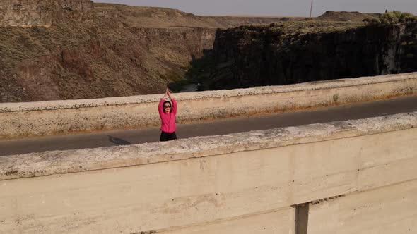 Aerial of a woman hiking across the Salmon Falls Dam in Southern Idaho