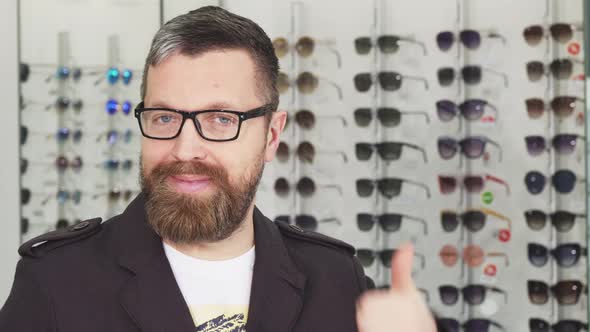 Happy Mature Man Showing Thumbs Up at the Eyewear Store