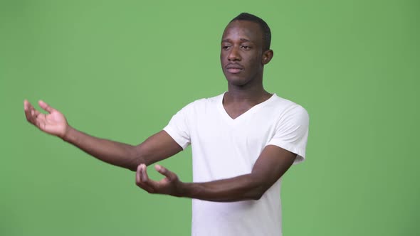 Young African Man Showing Something
