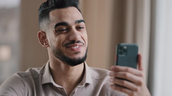 Happy Young Hispanic Guy Businessman Handsome Man Freelancer Smiling Talk By Video Call on