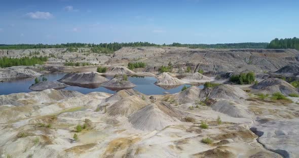 Lake Hides Behind Lifeless Clay Pit Petrified Surface