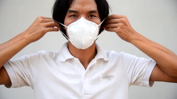 A asian man wear Hygienic mask for protect PM2.5 Dust 