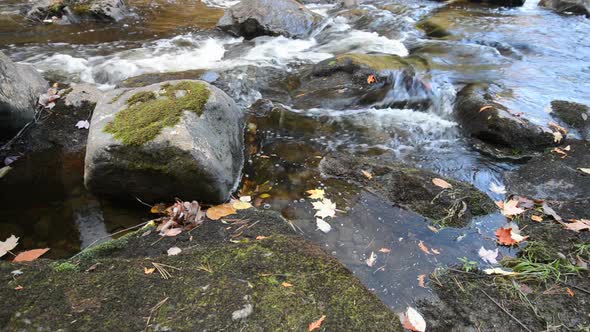 Close Up View of a Stony Riverbed and Silver Stream