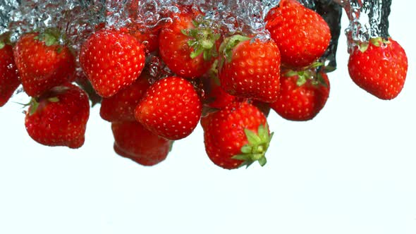 Super Slow Motion Shot of Falling Strawberries Into Water at 1000Fps