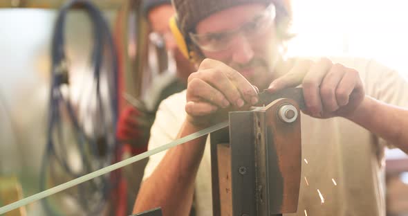 Bladesmith sharpening a blade on belt grinder