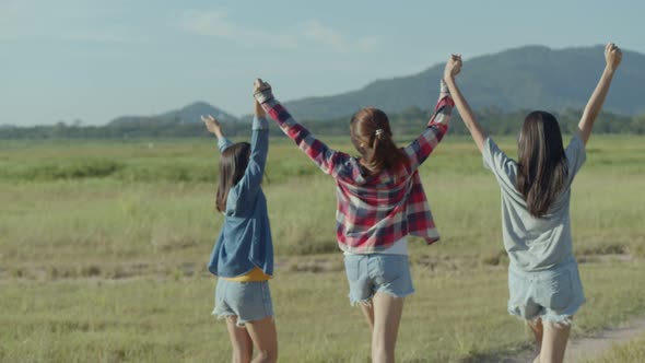 Group of young Asian women running having fun together a summer traveling.