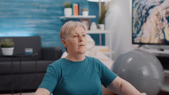 Handheld Shot of Elder Person Using Resistance Band to Exercise