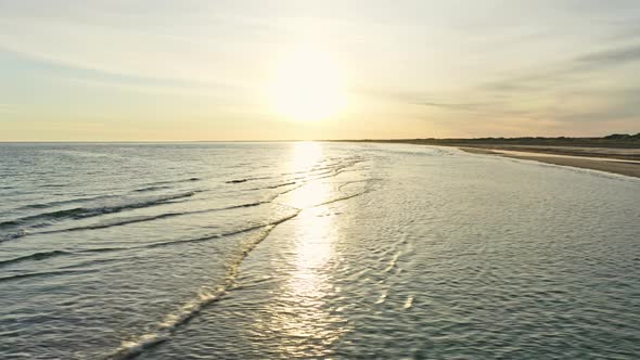 Calm Deep Blue Seas and Sandy Beach in Denmark During Sunrise