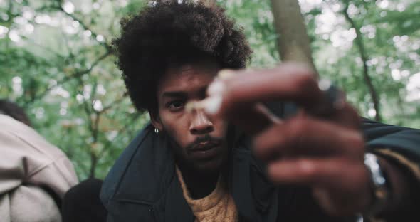 Man looks closely at tiny mushrooms