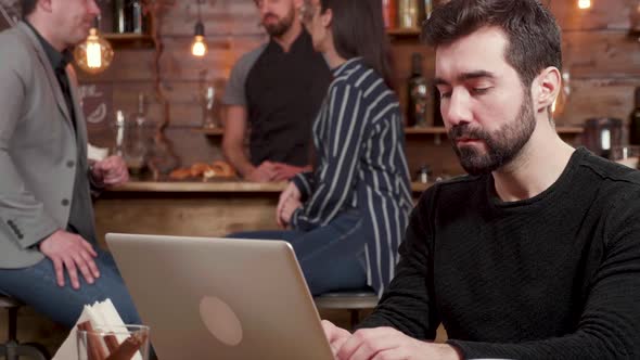 Portrait of a Young Freelancer Typing and Thinking About the Text on His Computer