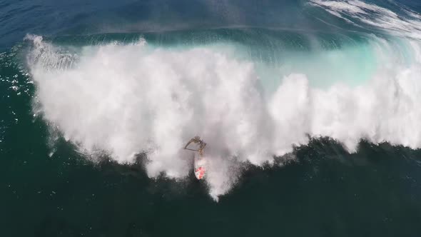 Aerial view of a man sup stand-up paddleboard surfing in Hawaii.