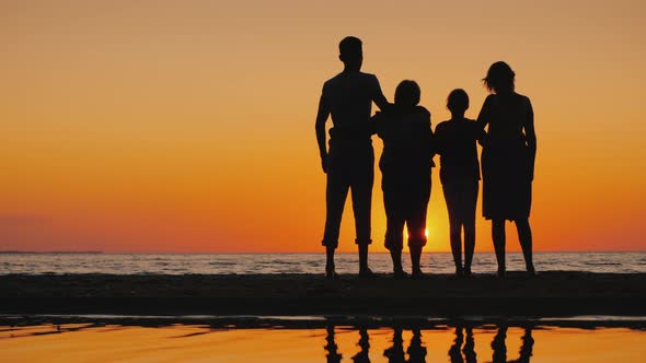 Friendly Multigenerational Family Together Standing Next to the Sea Looking at the Horizon