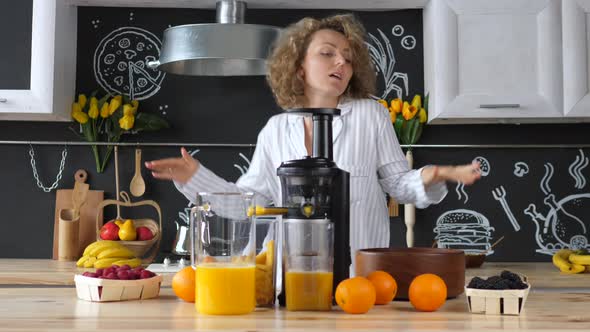 Happy Young Woman Dancing At Home Kitchen Wearing Pajamas