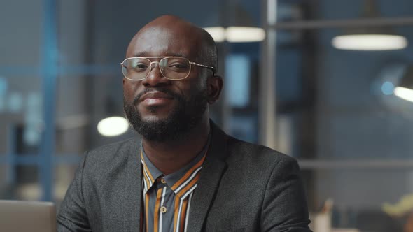 Portrait of Cheerful Black Businessman Working Late in Office