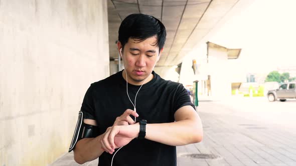 Man Using Smartwatch While Jogging