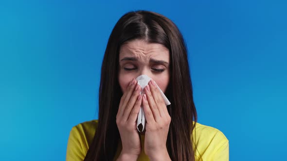 Ill Woman Sneezes Into Tissue