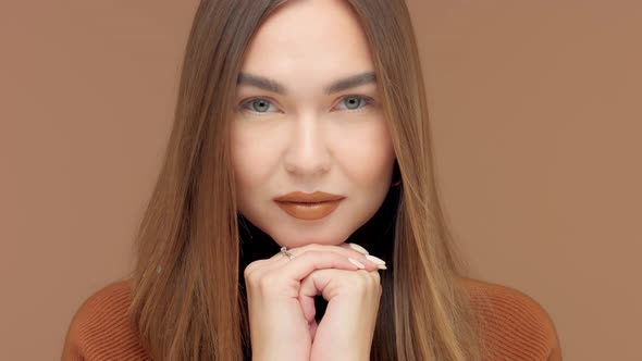 Monochrome Brown Look Caucasian Woman in Studio Portrait with Hair Blowing