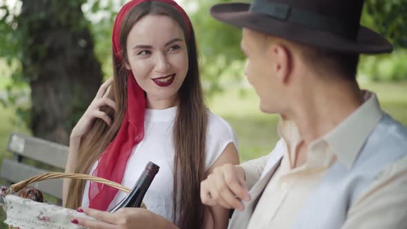 Charming Young Brunette Woman Talking with Elegant Young Man Outdoors, Portrait of Beautiful