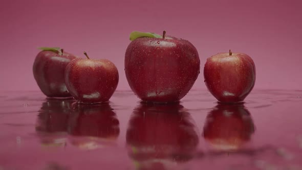 Red Sweet Apples Jump Natural Fruits Isolated on Red Pink Background