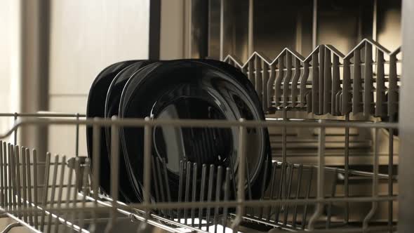 Dishwashing machine basket with porcelain dishes close-up slow-mo 1920X1080 HD footage - Drawer insi