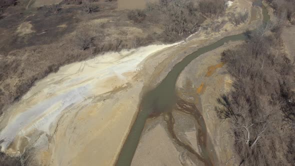 Pyrite on river coast from mine drainage 4K aerial video