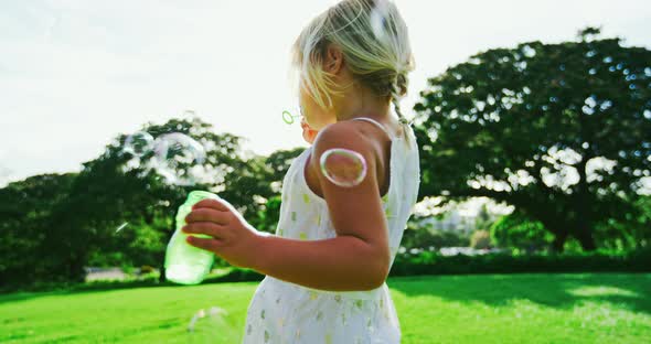 Young Girl Blowing Bubbles