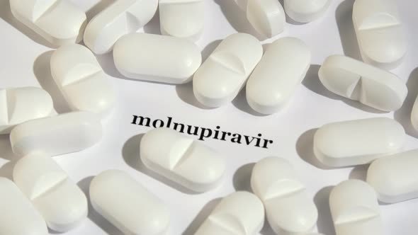 Closeup Shot of White Tablets on White Background with Black Text