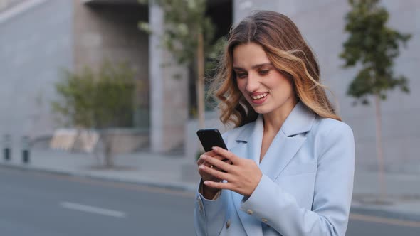 Female Portrait in City Young Blonde Girl Business Woman User Stands on Street Looking at Mobile