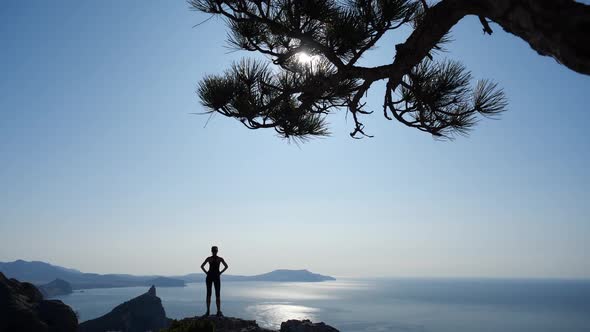 The View From the Back of Sporty Young Girl Who Stands on Mount in Sudak, Crimea