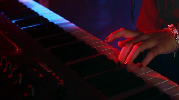 Woman playing electronic keyboard