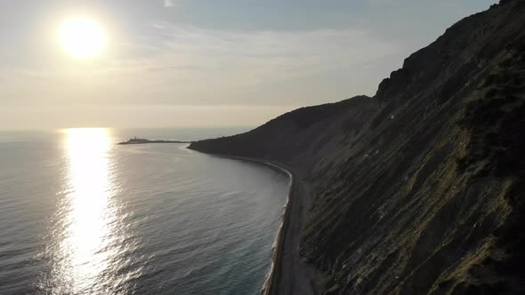 Aerial Cinematic: a Drone Flying Along the Seashore at Sunset, The Drone Is Flying Over the Sea