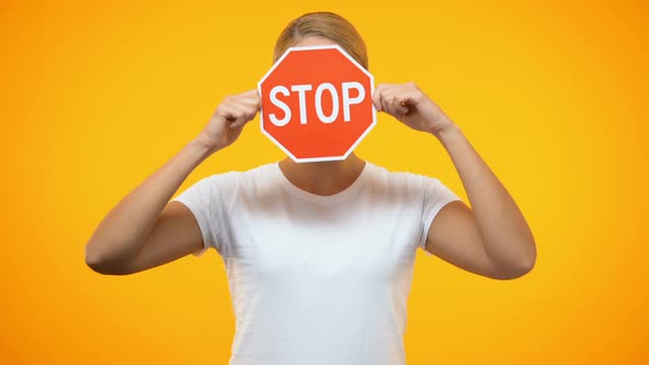 Serious Woman Holding Red Stop Sign Front Face, Negative Sign, Warning Problem