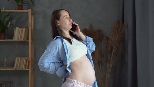 Real Young Pregnant Woman Talking on Mobile Phone Consulting Doctor Contraction Back Pain Calling