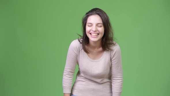 Young Happy Beautiful Woman Laughing Against Green Background